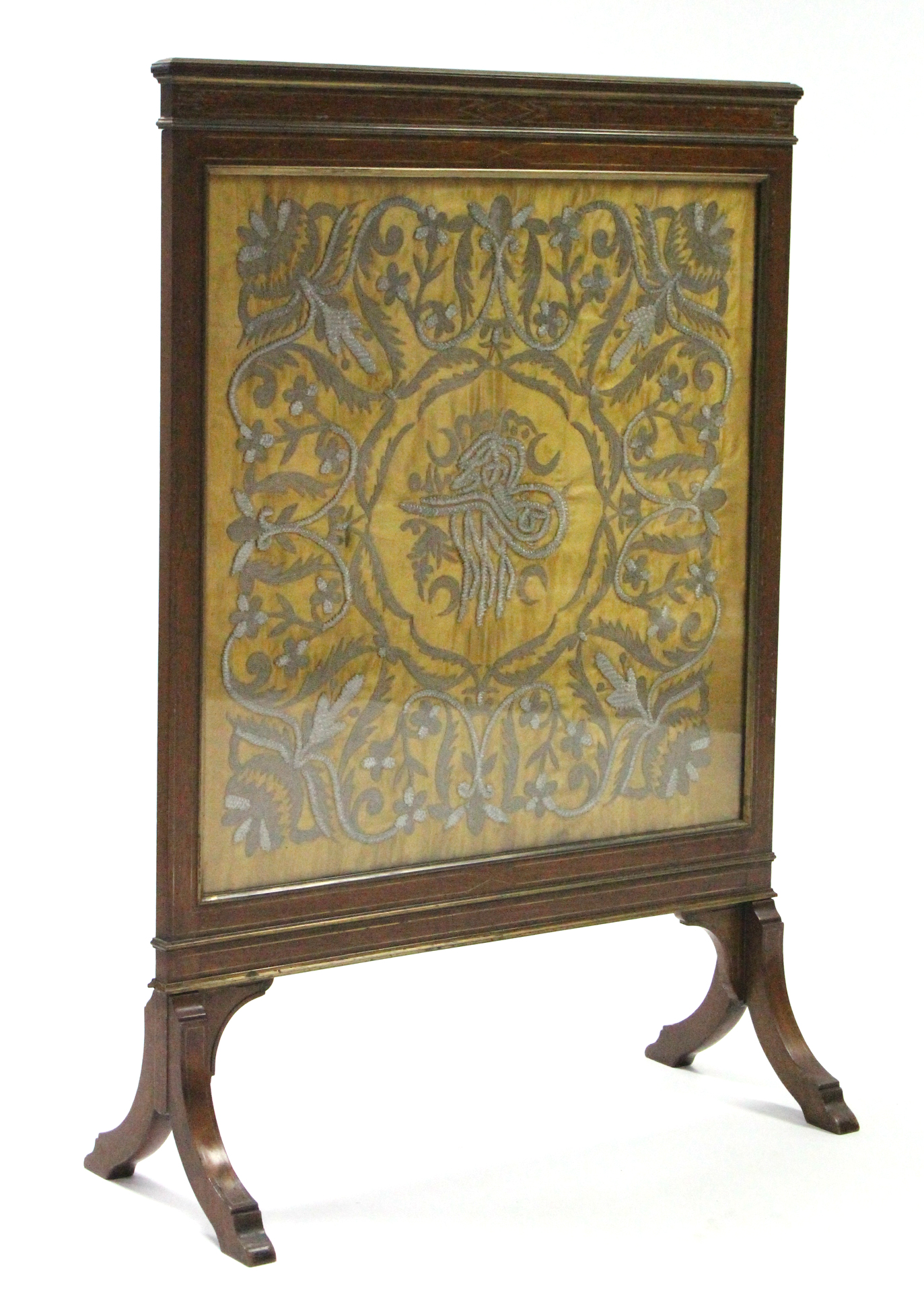 A Victorian mahogany & brass-inlaid firescreen, inset embroidered silk panel, on splay feet; 26"