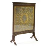 A Victorian mahogany & brass-inlaid firescreen, inset embroidered silk panel, on splay feet; 26"