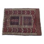 A Persian prayer rug of crimson, dark blue & ivory ground, with cross motif to the central panel