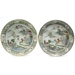 A pair of 19th century famille verte porcelain 9½” diam. plates painted with figures in a river