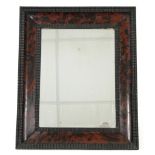 A 17th century-style tortoiseshell-veneered picture frame converted to a wall mirror, with ripple-