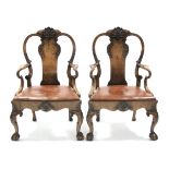 A pair of George II-style carved walnut armchairs by Charles Baker of Bath, the shaped splat-backs