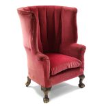 An 18th century-style armchair upholstered rose-pink velour, with tall rounded wing-back & on