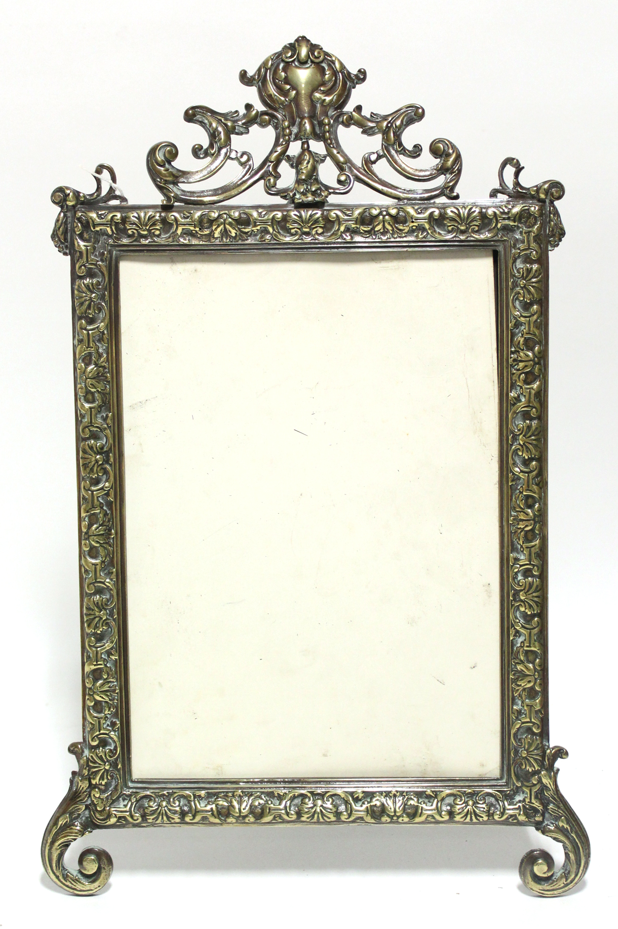 A 19th century rectangular cast brass picture frame with foliate border & pierced crest, on easel