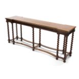A Victorian mahogany side table with shaped rectangular top on barley-twist supports joined by