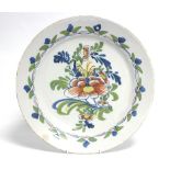 An 18th century English polychrome delft charger painted with bold floral design, possibly