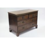 An early 19th century mahogany chest, fitted two short & two long graduated drawers with brass