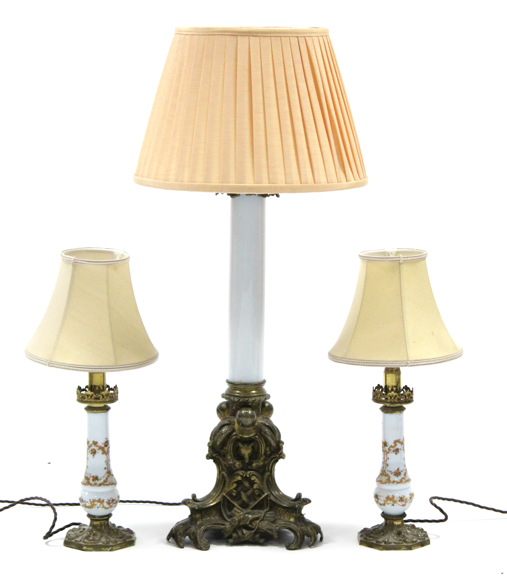 An Edwardian table lamp on opaque glass centre column & brass foliate triform base, with shade;