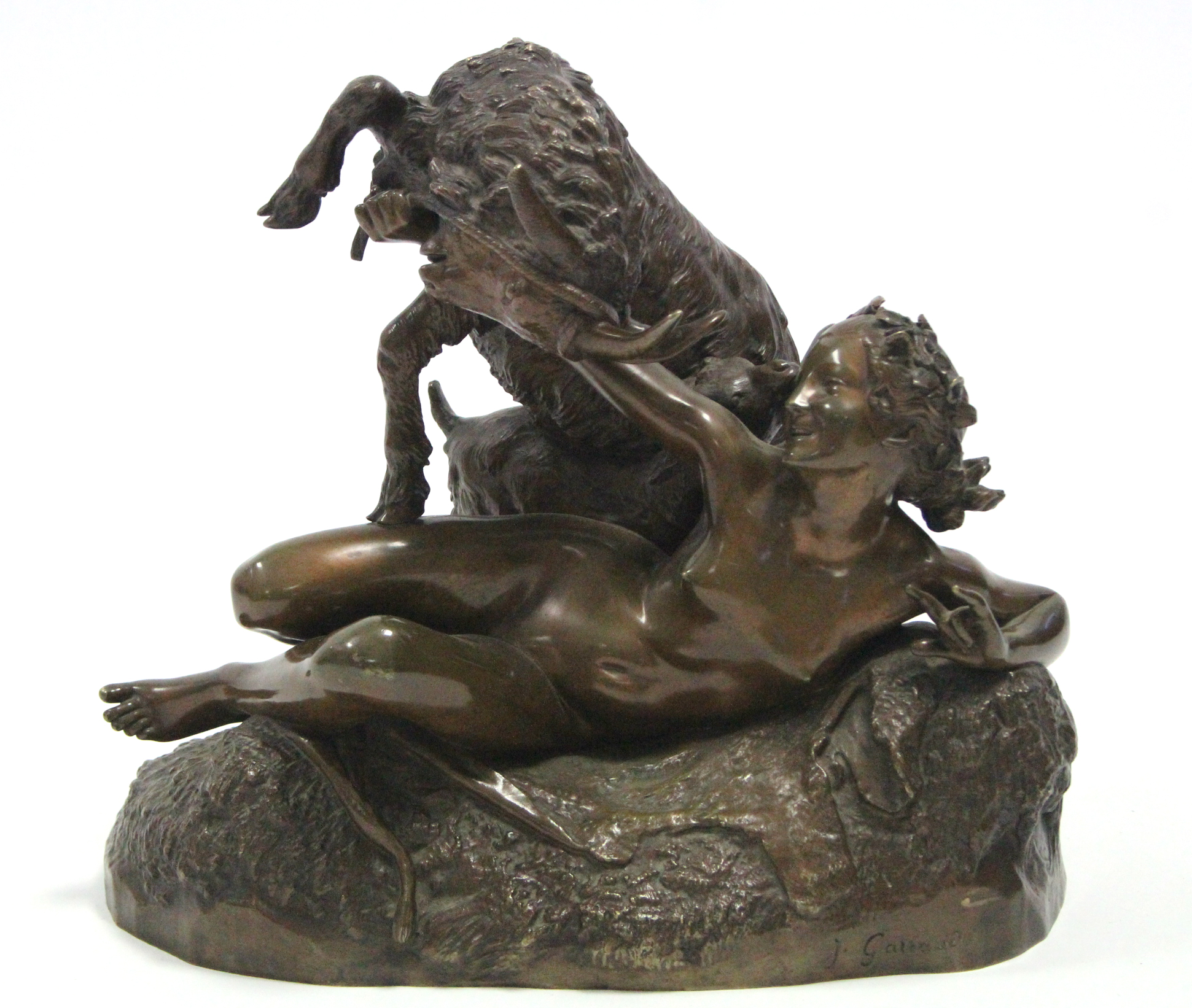 GAREAUD, J. A bronze group of a nude female figure reclining on an animal skin, a goat & kid