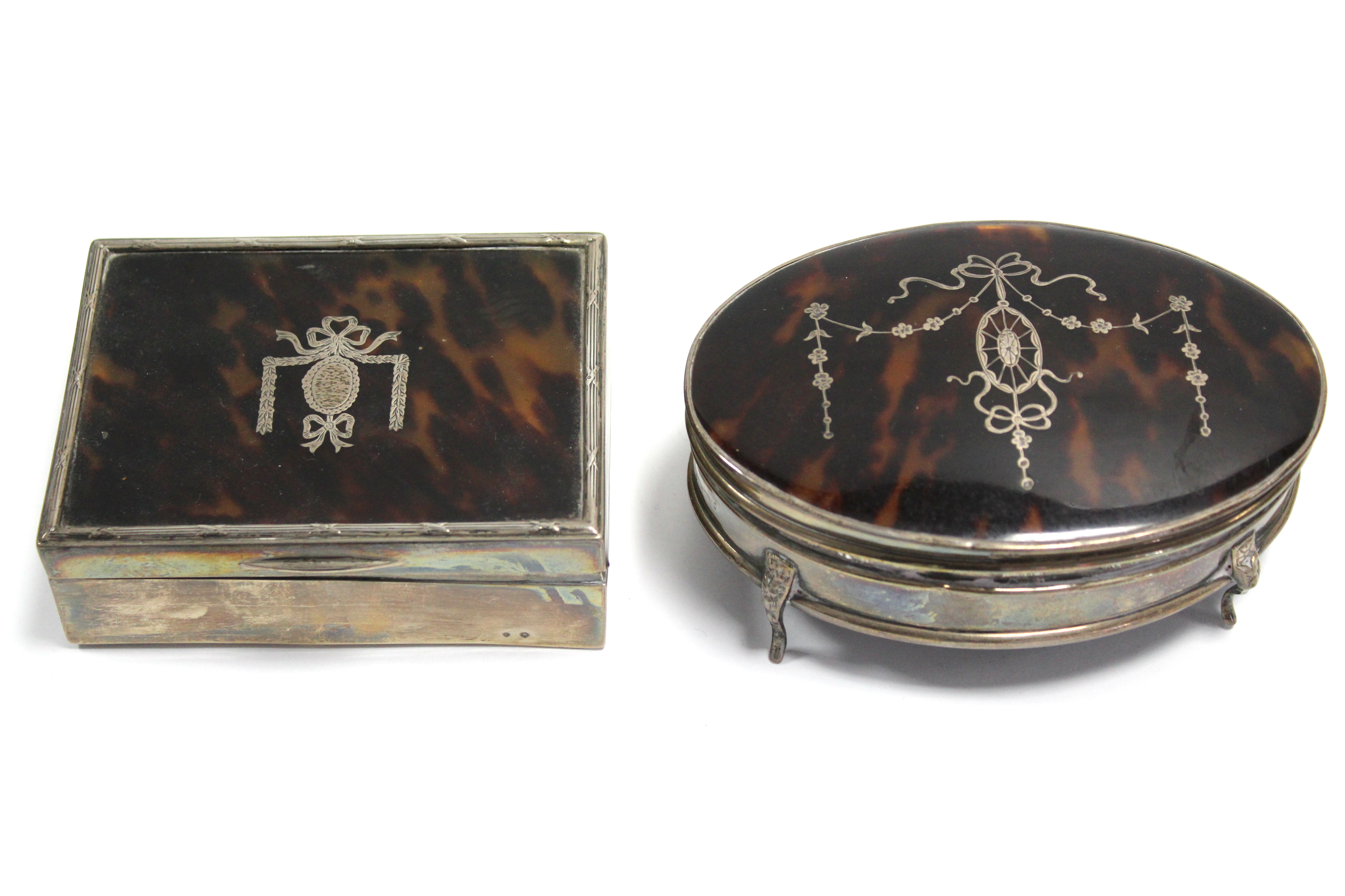 A rectangular trinket box with silver-inlaid hinged lid, 4½” wide, London 1915 by Corke Bros.; & a