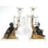 A pair of 19th century bronzed & gilt composition, & cut glass candle stands with putto & oak-branch