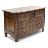 A LOUIS XV PROVINCIAL WALNUT & OAK COMMODE, fitted two short & two long drawers with carved fronts &