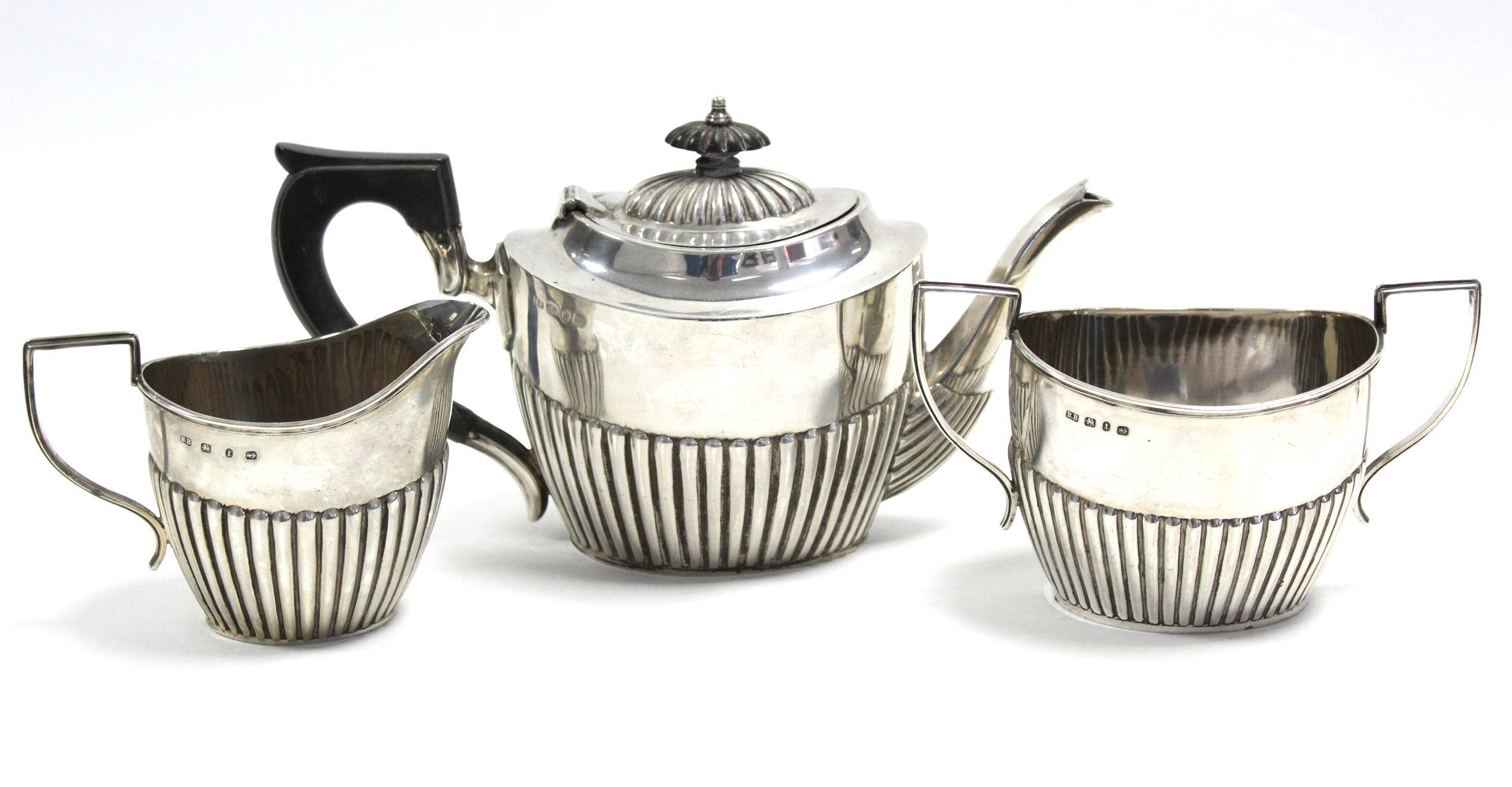 A late Victorian oval semi-fluted three-piece tea service; Birmingham 1892-3, by Barker Bros. (23