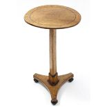 A Biedermeier bird's-eye maple & ebonised pedestal table, the circular top on triform centre