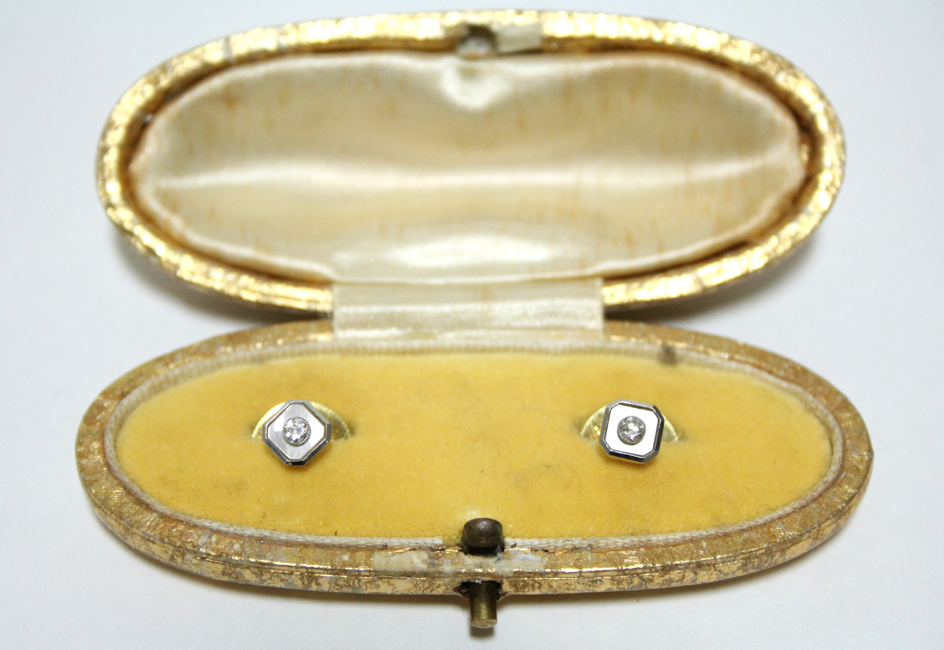 A pair of 18ct. gold dress studs, each with diamond-set mother-of-pearl square panel.