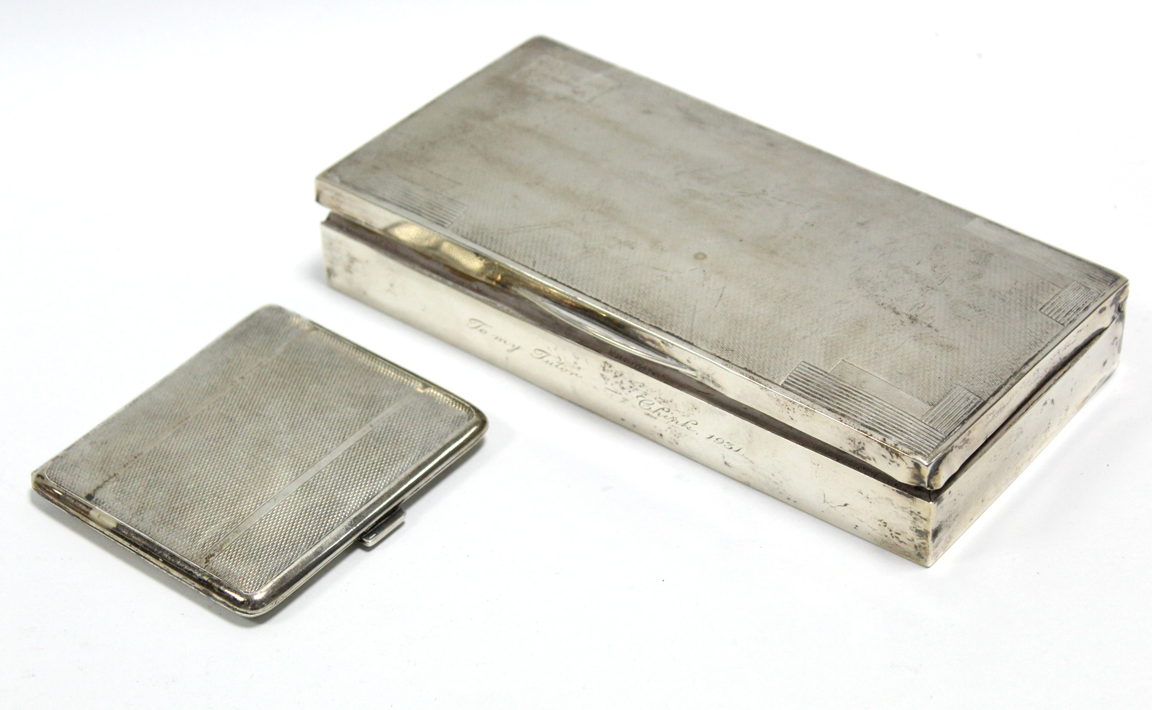 A rectangular cigarette box with art deco style engine-turned hinged lid, 4“ wide, London 1931; & a