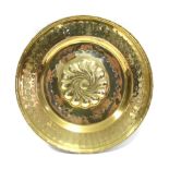An 18th/19th century brass alms dish with spiral boss to the centre; 16” diam.