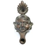 A 19th century Italian Grand Tour renaissance-style oil lamp in the form of a human face, 7¾” wide;