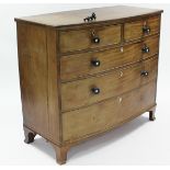 A late George III mahogany bow-front chest of two short & three long graduated drawers with ebonised