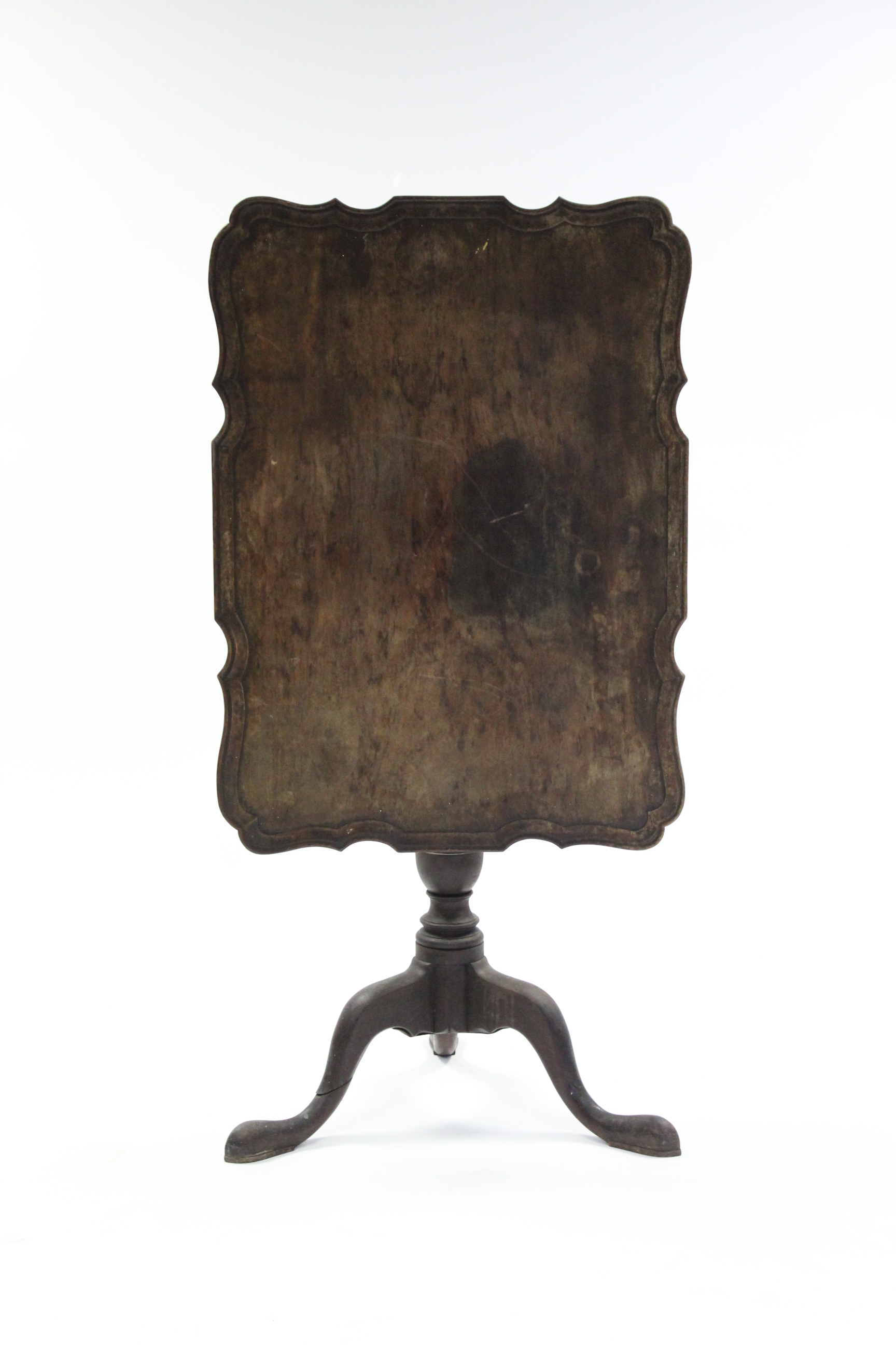 A George III-style mahogany tripod table, the rectangular top with pie-crust edge, on turned &