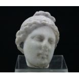 A classical sculptured white marble head of a Goddess; 3” high.