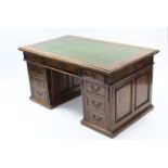 A Victorian walnut pedestal desk, inset gilt-tooled leather top, fitted frieze drawers above two