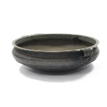 An Oriental bronze shallow circular two-handled food bowl, an inscription to the rim; 24” dia. x
