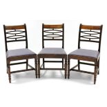 A set of three regency mahogany dining chairs with ebony-strung top rails, the open backs with