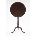 A late George III mahogany tripod table, the circular tilt-top on vase-turned & spiral-fluted centre