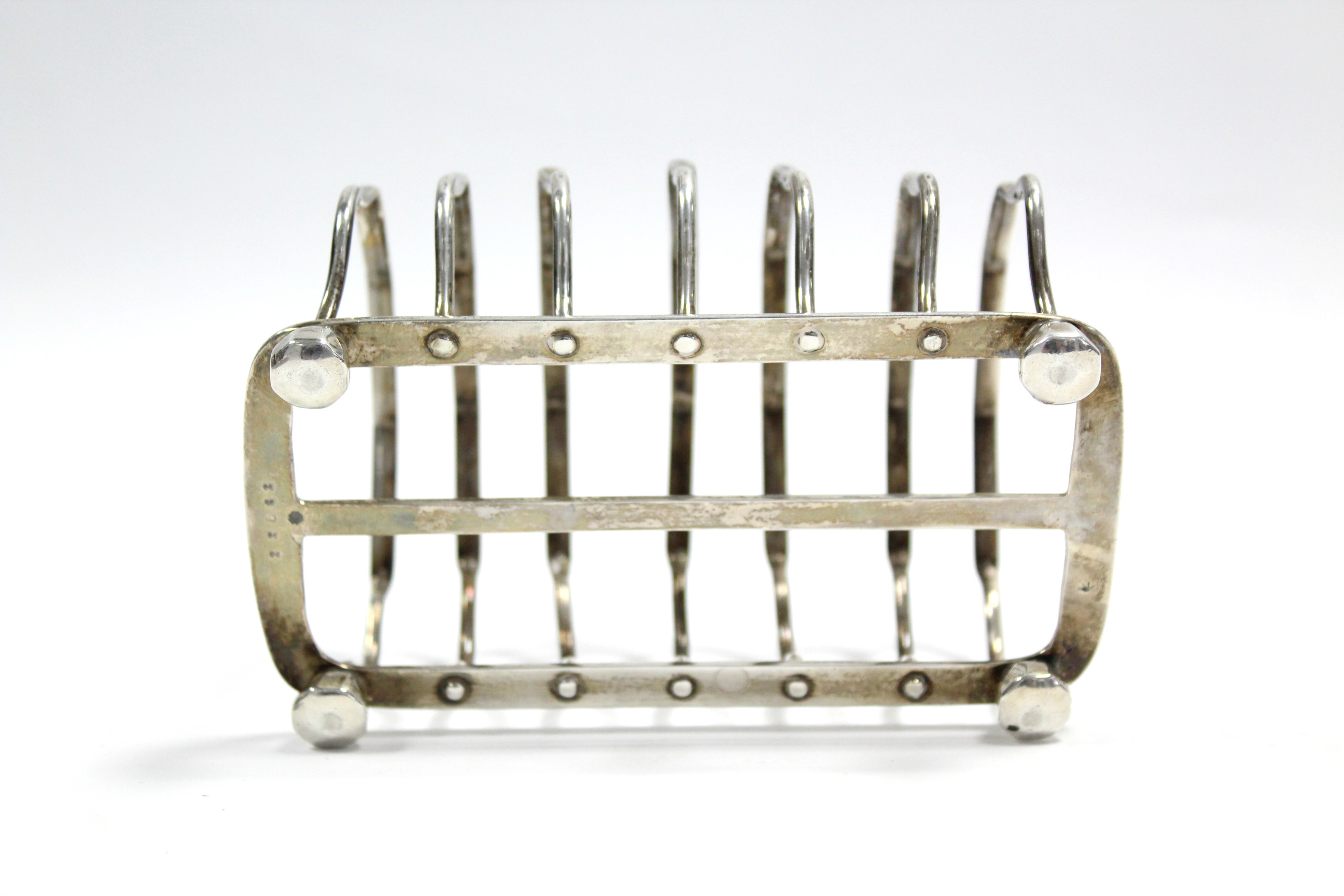 A George V six-division toast rack with centre ring handle, on four octagonal bun feet, 5¼” long; - Image 2 of 2