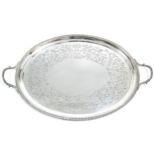 An Edwardian oval two-handled tray with floral-engraved wide border & gadrooned rim, 22” x 14”,