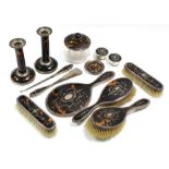 An Edwardian silver-inlaid tortoiseshell hand mirror, pair of matching clothes brushes, & hair
