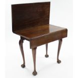 A late 18th century mahogany tea table with rectangular fold-over top, & small drop leaf to one