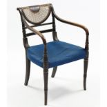 A regency painted beech elbow chair with cane back, padded seat & turned tapered legs, (the