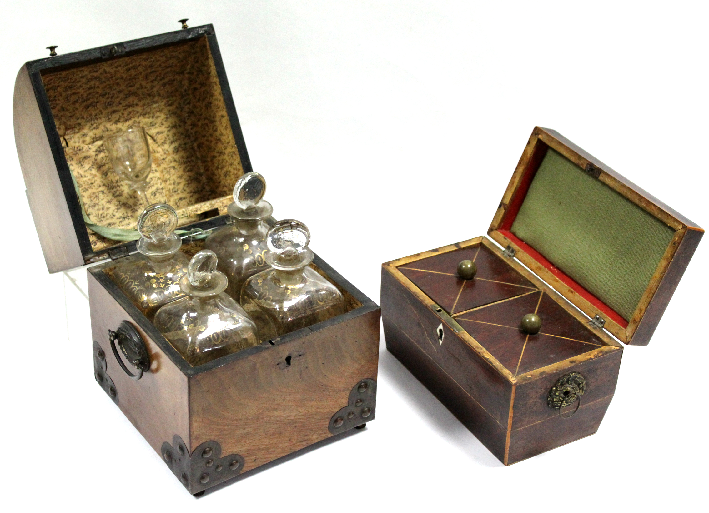 An early 19th century figured mahogany square decanter box with cylinder front to the hinged lid,