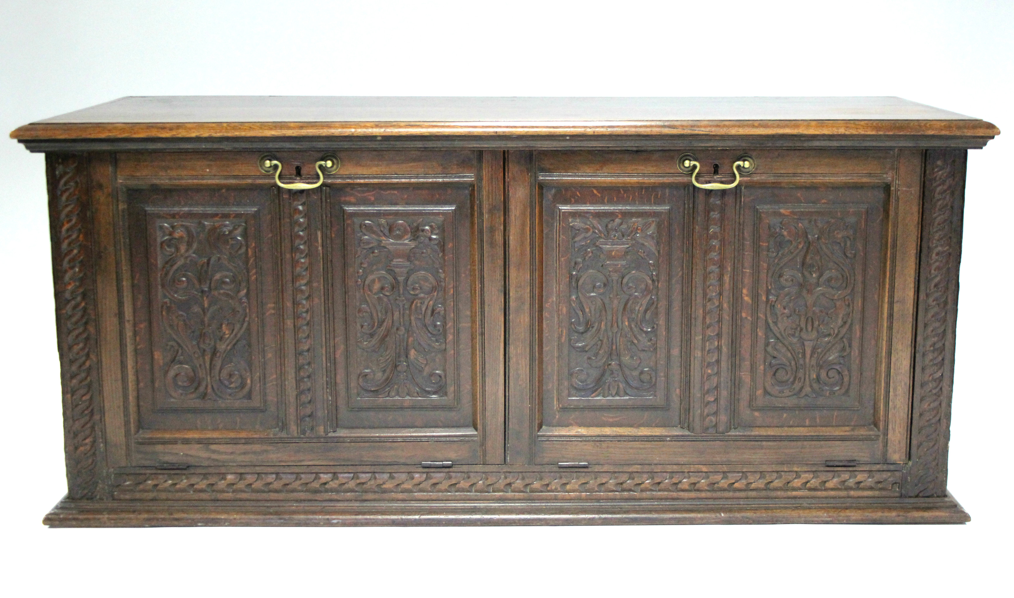 A late 17th century style converted mule chest, the four-panel front carved with mythical beasts,