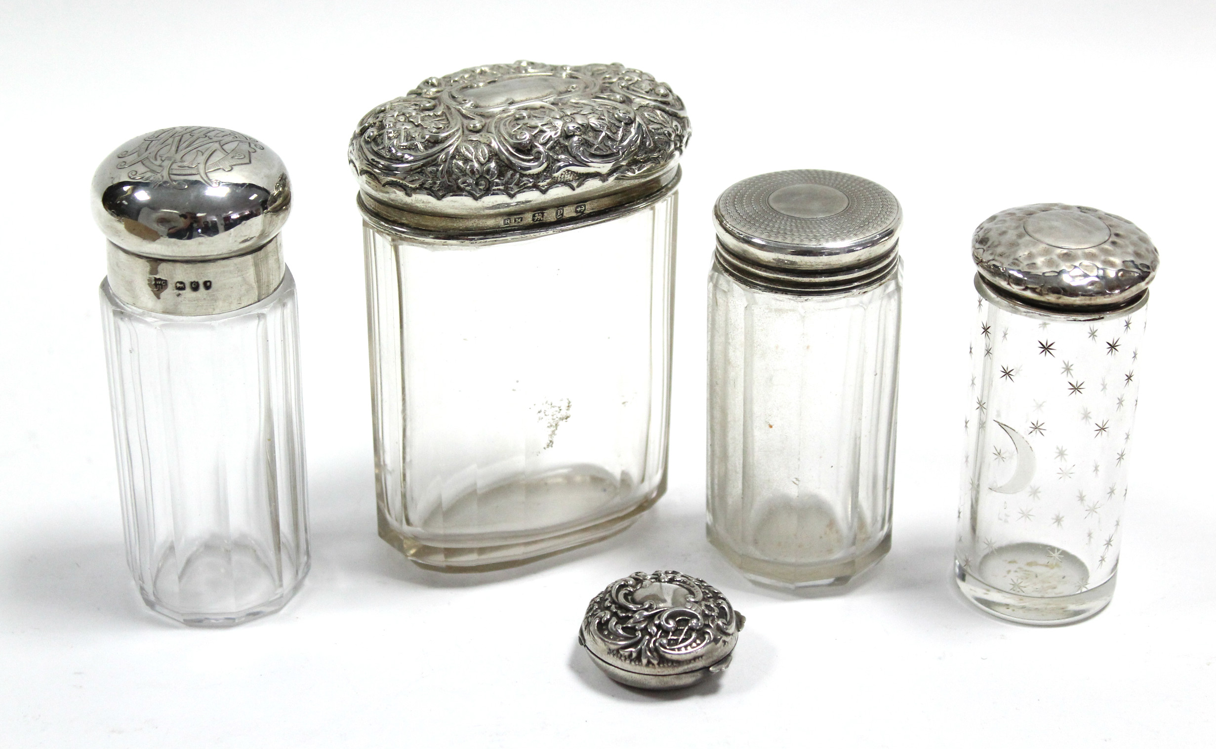 An Edwardian circular pill box with embossed hinged lid, Birmingham 1902; & four cut glass