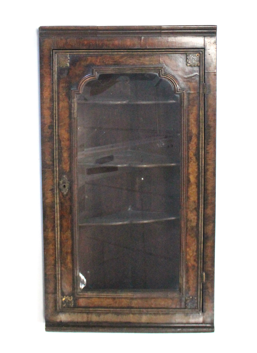 A 19th century burr-walnut hanging corner cabinet in the William & Mary style, fitted three shaped