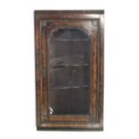A 19th century burr-walnut hanging corner cabinet in the William & Mary style, fitted three shaped