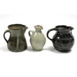A St Ives studio pottery 4.5“ bulbous jug of speckled blue over chocolate brown glaze with waved