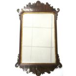 An 18th century rectangular wall mirror inset bevelled plate, in mahogany frame with fret-carved