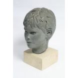 A green painted plaster head of a young boy, on stone block base; 13½” high over-all.