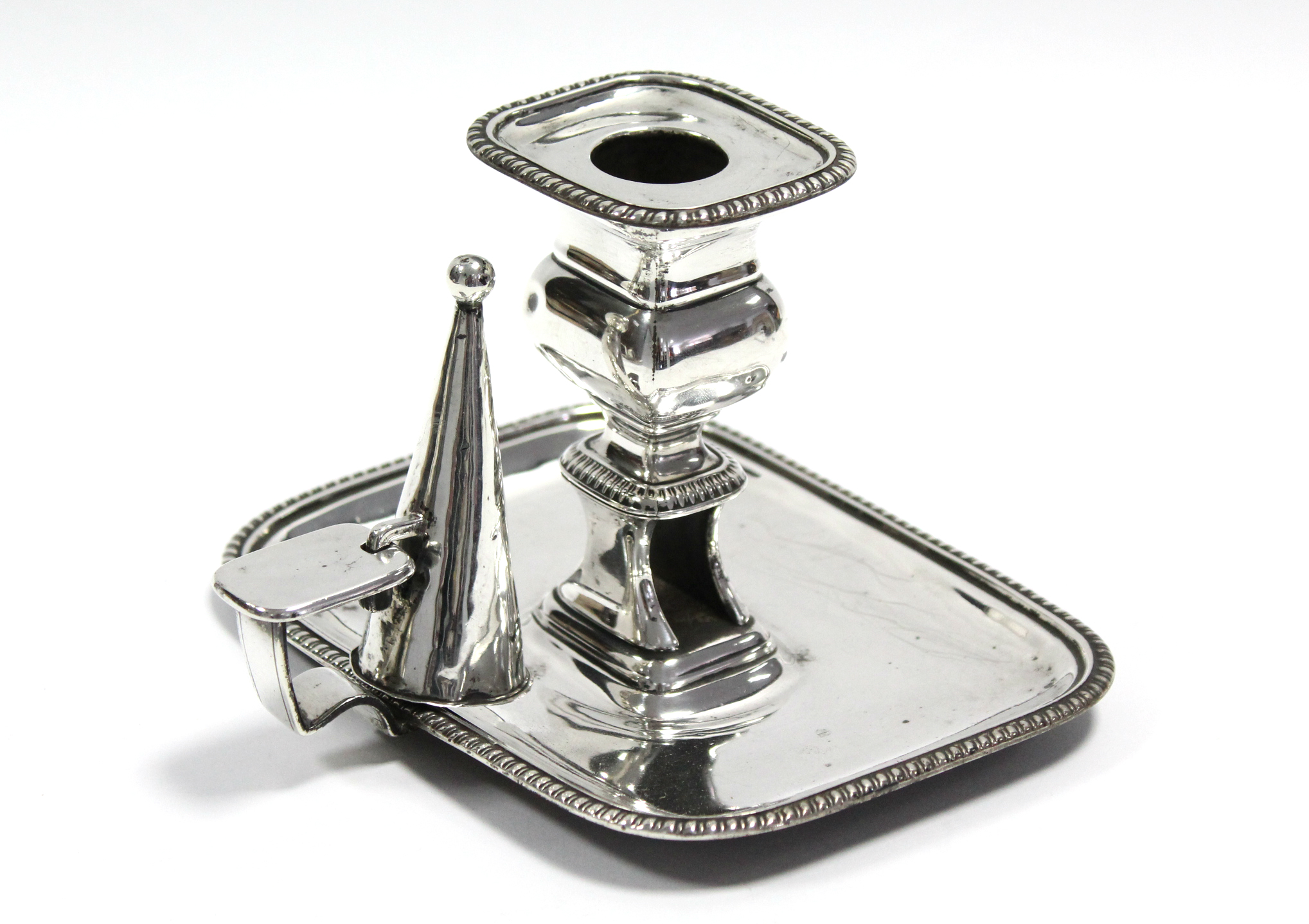 A George III chamber candlestick with egg-&-dart borders, snuffer cone, & snuffers holder to the