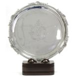 A GEORGE III CIRCULAR SALVER with gadrooned shell & leaf-scroll border, engraved armorial to the