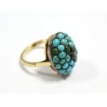 An 18ct. gold ring set oval cluster of turquoise beads centred by a small diamond. (size K).
