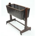 A Victorian walnut cradle with lattice sides, swing on plain end supports; 39" long x 34½" high.