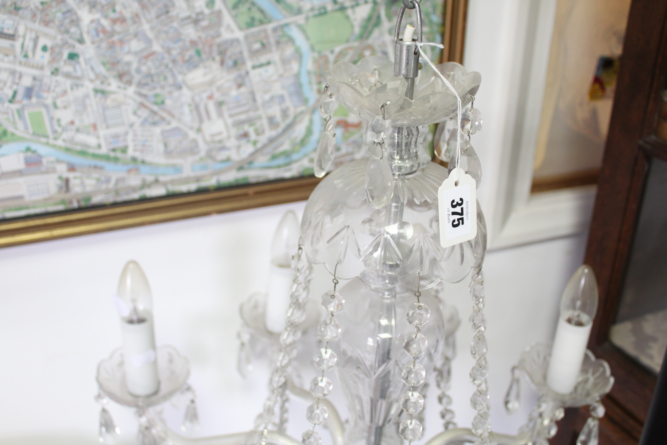 A cut glass chandelier with eight scroll arms with pendant prism drops, the slender baluster - Image 2 of 5