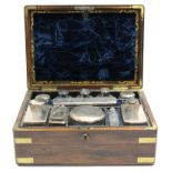 A mid-19th century rosewood & brass-mounted travelling toilet case, the fitted interior with