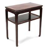 A Chinese hardwood two-tier side table, the rectangular top with moulded edge, & on four square