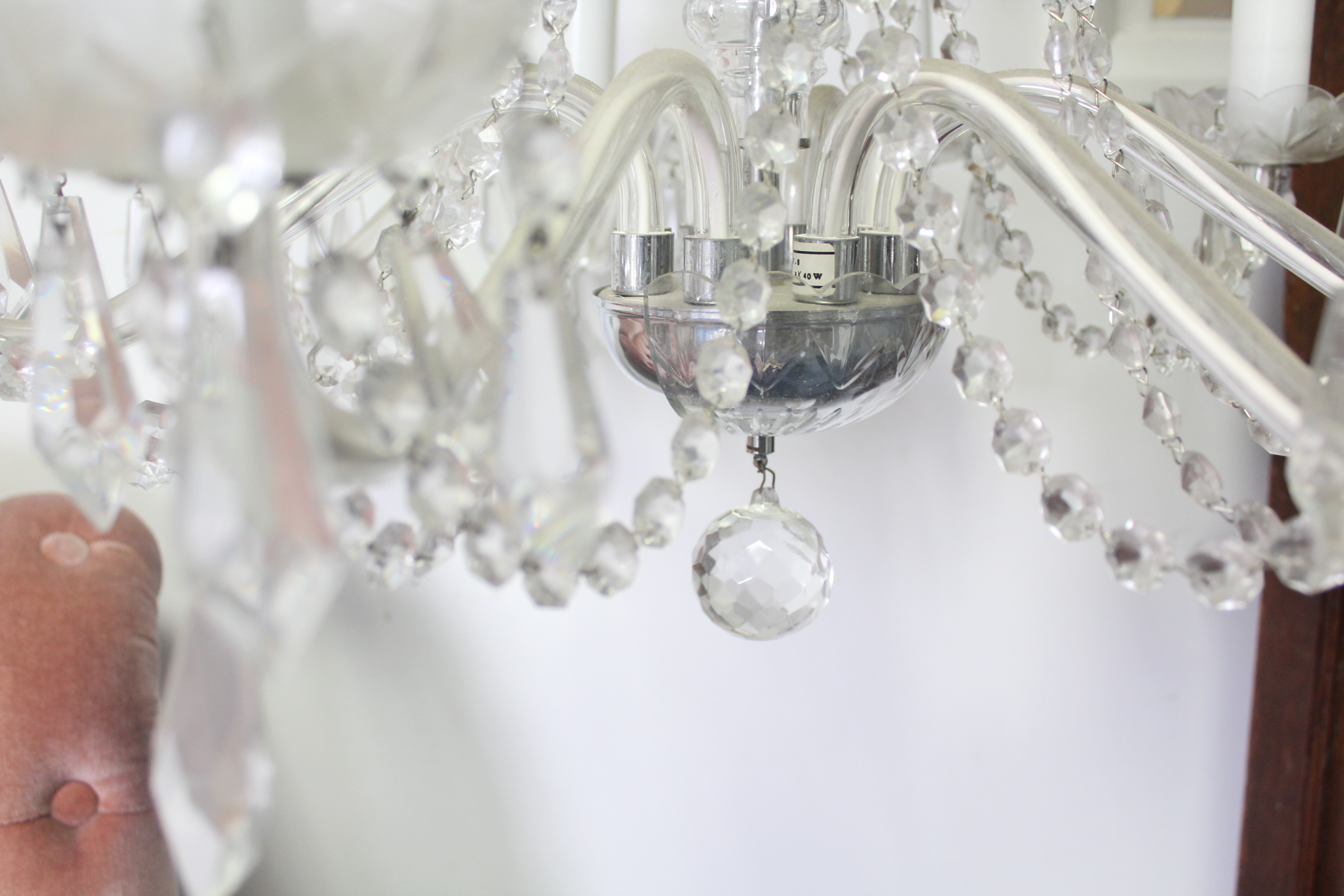 A cut glass chandelier with eight scroll arms with pendant prism drops, the slender baluster - Image 4 of 5